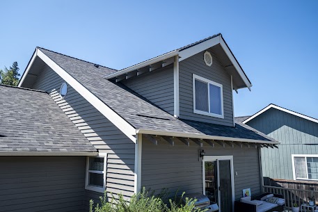 Completed roof replacement on a two-story home in Vancouver WA, complex multi-gable roofline with dark architectural shingles